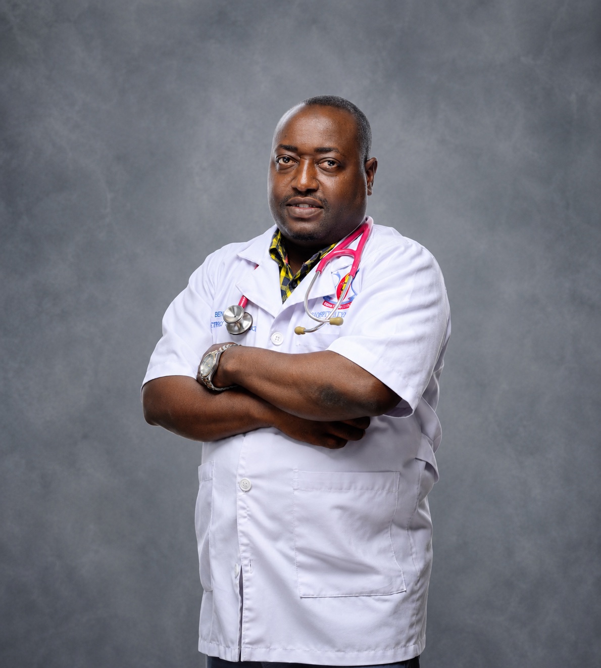 Portrait of Dr. Benny wearing a white clinical coat and stethoscope